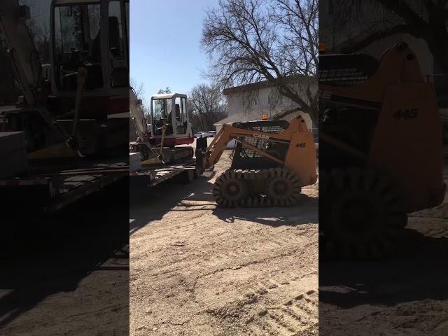 Skid steer ready to move stones off trailer and excavator ready to leave job #landscaping #landscape