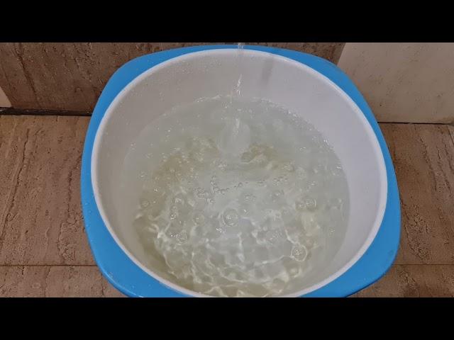 Mesmerizing Water Flow: Filling a Bucket with Tap Water