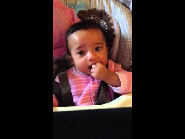 Ella Ruth dancing in the highchair