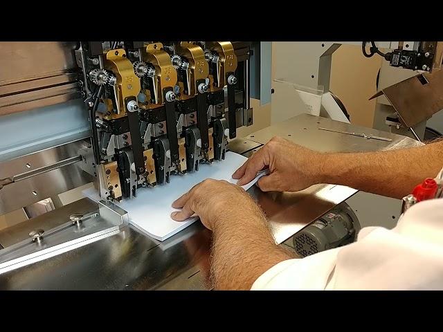 Deluxe Stitcher M17 machine with G8 heads stitching a 1/4" thick pad