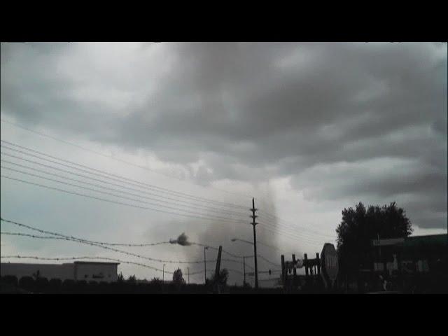 Workers take cover as tornado forms overhead