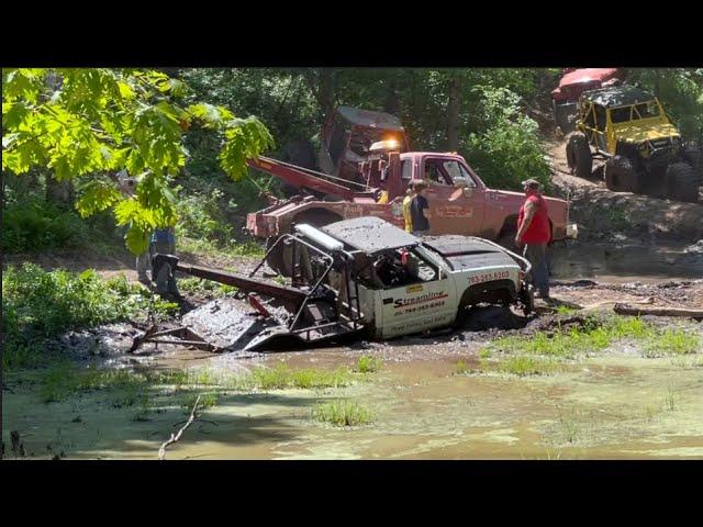 Off Road Wrecker buried in the mud 44 inch tires covered