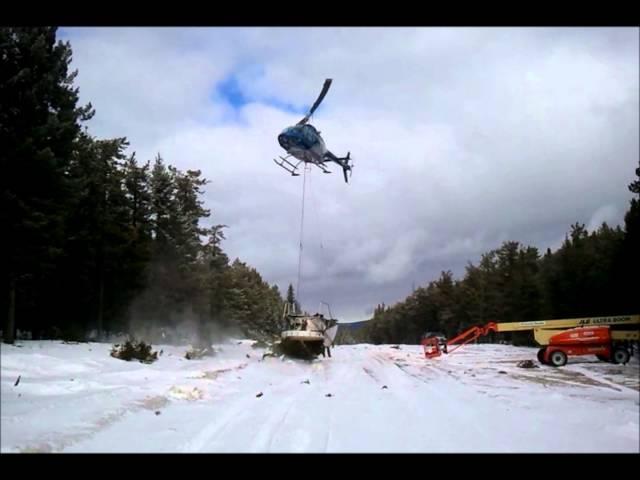 Helicoptor Cutting Tree Tops for Pine Cones