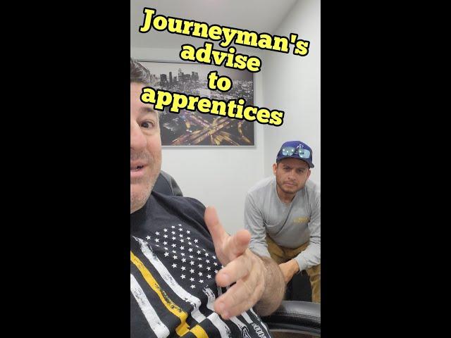 Journeyman gives advice to apprentice electrician