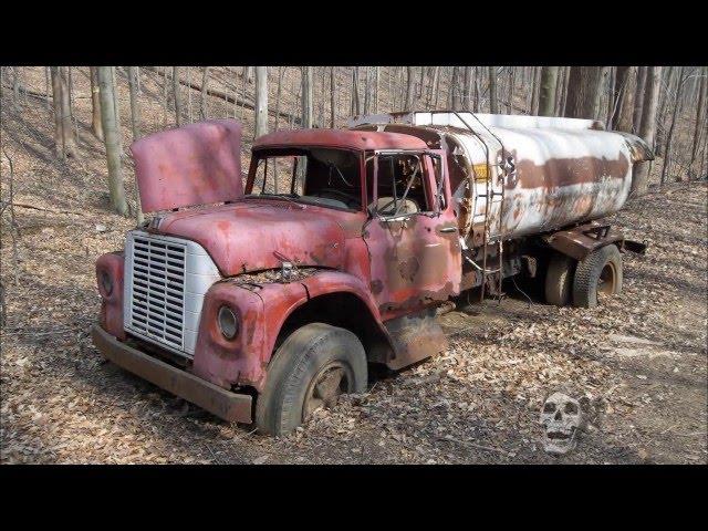 Abandoned trucks in woods in America. Abandoned pickup in USA. Abandoned semi truck