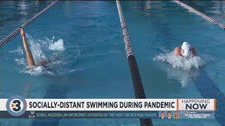 Athletes adapt to socially distant swimming during pandemic