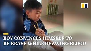 Cute boy convinces himself to be brave while while drawing blood in China