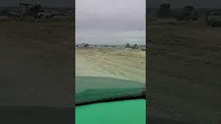 Roll off dumpster at Williamson County Hutto landfill. Windy day with trash flying everywhere