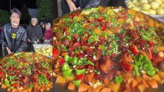 A Chinese Guy Cook Pork Meat Potato Noodles Rice Food for the old on the Street in a Village