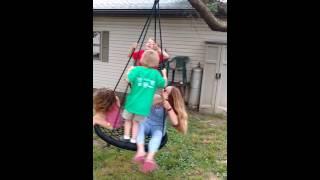 Neighbors playing on the new swing