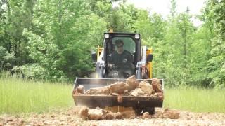 Lonking CDM308 Skid Steer digging with the standard bucket attachment