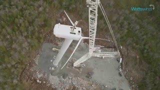 Drone video of a wind turbine being pieced together into the night