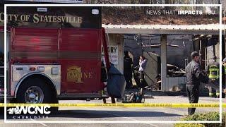 Person killed after car crashes into Statesville laundromat, causing fire