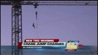 Man charged for jumping off crane