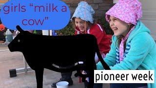 Pioneer week\\Girls “milk a cow”  