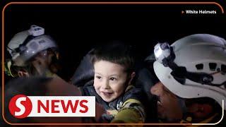 Syrian boy smiles after being pulled from quake rubble