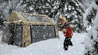 COZY TENT CAMP WITH STOVE IN HEAVY SNOWFALL