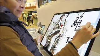 Shuen Leung trying out Surface Studio & Surface Book 2