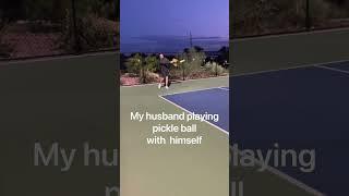 My husband playing pickle ball with himself