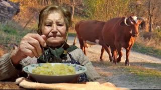 Life in a Mountain Village: An 80-Year-Old Woman Making Homemade Polenta with Milk