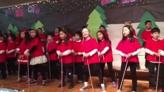 Marisa's grade 2 class performs "rocking around the Christmas tree"