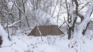 hiding in winter hot tent from the rain , bushcraft trip in canvas shelter
