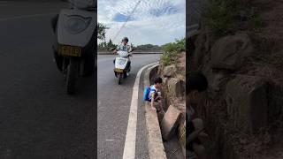 The boy on the scooter fixed the pipe on the road #shortvideo