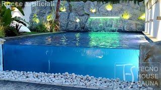 Piscine naturali con rocce artificiali, parete rocciosa e cascata