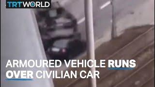 Armoured vehicle drives over a civilian car in Kiev