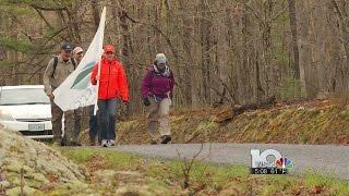Dozens hike 20 miles to honor group's 20th anniversary