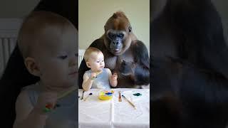 Baby and gorilla draw together.