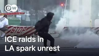 Los Angeles riot police fire 'flash-bang' rounds at protesters after violent immigration raids