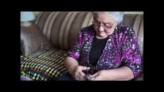 Inuit Elder Nellie Winters makes an Inukshuk out of seal skin.