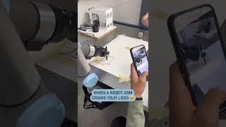 Students in the Robotic Systems Lab programmed this robot arm to draw our logo! 