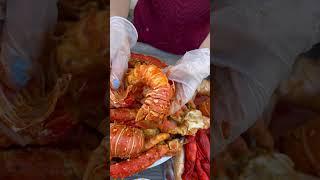 Top-ranking seafood boil : indulge in juicy lobster tail dipped in spicy cajun sauce