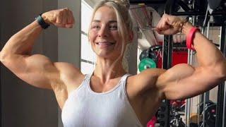 Beautiful muscular woman flexing big biceps