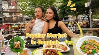 Thai Girls explore the popular outdoor market in Bangkok, Thailand