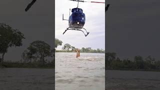 The helicopter passes through the village sky. Then