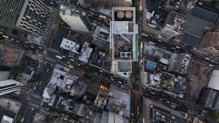 Bird's eye views showcase Manhattan's streets and rooftops of New York City at dusk, capturing