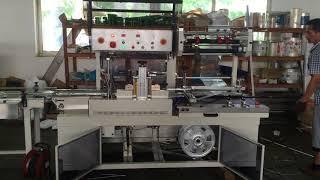 Shrink wrapping machine