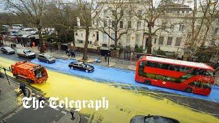 Giant Ukrainian flag painted by protesters outside Russian Embassy in London