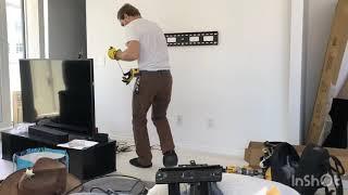 Time-lapse TV and shelf wall mounting with cords concealed.