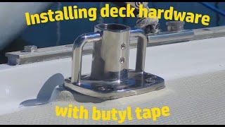 Installing deck hardware (stanchion base) with butyl tape.