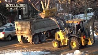 Front-loader tractor loading heavy trucks and moving heavy stuff