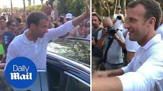 President Emmanuel Macron greets locals during summer holiday