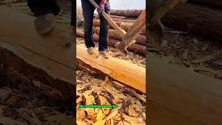 Debarking a Wooden Log with a Long Ax