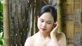 Lush rice fields are tended by a girl, bathing and cooking after a day of work