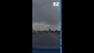 Dash cam video shows moment piece of metal went through the windshield of car on I-15