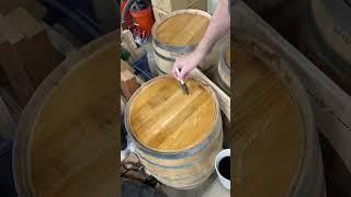 Using some black coffee to darken the surface of this whiskey barrel top.