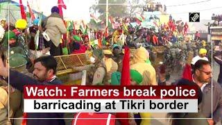 Watch: Farmers break police barricading at Tikri border